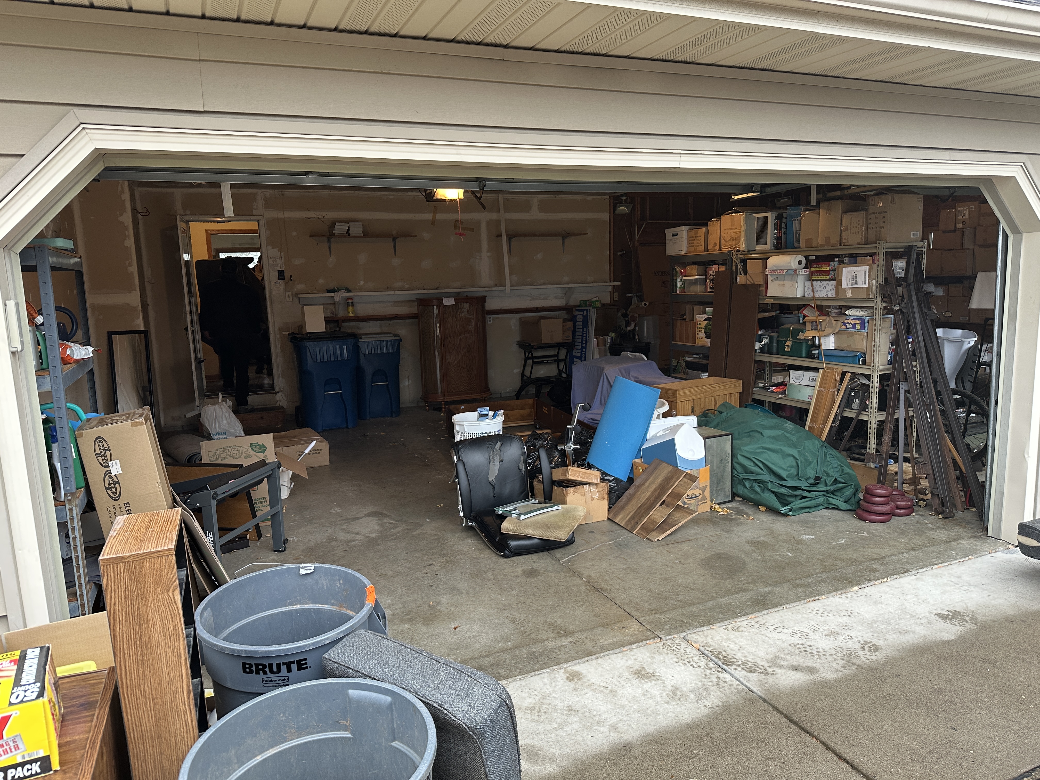 Cluttered garage before cleanout